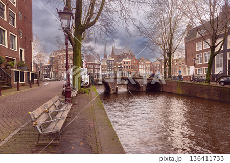 Historic Canal Bridge with Church in Amsterdam, Netherlands 136411733