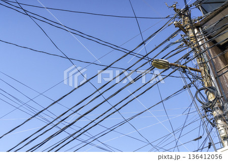 Tangled Power Lines and Utility Pole Against Clear Blue Sky. High quality photo 136412056