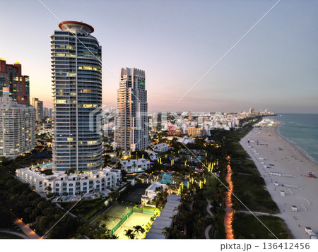 Miami South beach at night. Aerial view on skyscraper cityscape at night. Night city aerial view. Luxury skyscraper in Miami, Florida. City skyline in evening sunset. Aerial waterfront cityscape 136412456