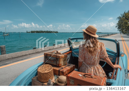 Vintage Convertible with Woman Enjoying a Scenic Drive Under the Sun by the Ocean 136413167