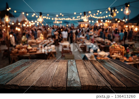 Vintage Wooden Table Perspective at a Festive Outdoor Gathering with String Lights in the Background Vintage Wooden Table Perspective at a Festive Outdoor Gathering with String Lights in the Background 136413260