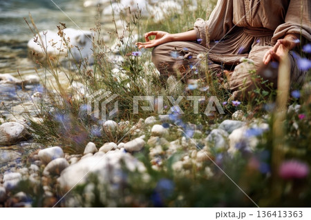 Serene Moment by a Flowing River with Hands in a Peaceful Meditation Pose 136413363
