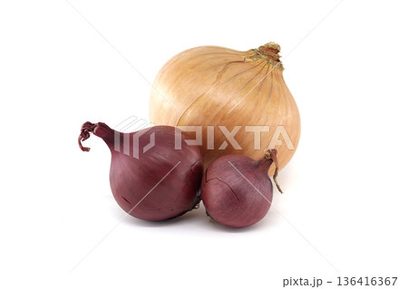 Three fresh onions, one yellow and two red, isolated on a clean white background 136416367