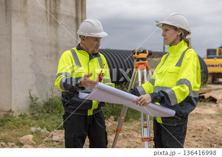 Engineer survey team checking construction project inspection work construction site . Engineer survey team checking construction project inspection work construction site . 136416998