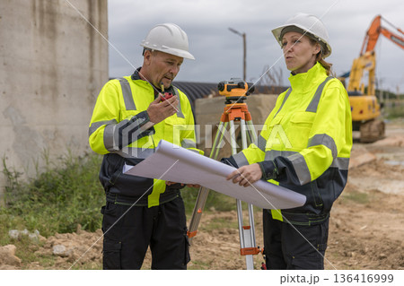 Engineer survey team checking construction project inspection work construction site . Engineer survey team checking construction project inspection work construction site . 136416999