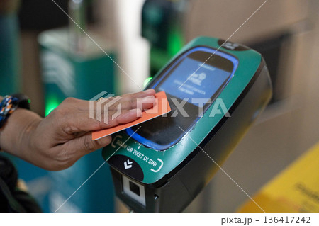 ジャカルタ MRT改札口でICカードをタップする手元 キャッシュレス決済イメージ ジャカルタ MRT改札口でICカードをタップする手元 キャッシュレス決済イメージ 136417242