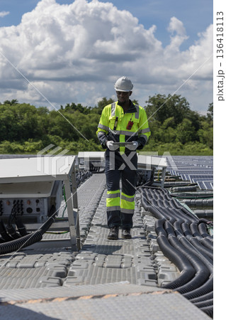 Engineer Checking and working setup Floating solar panels or solar cell Platform system on the lake.  136418113