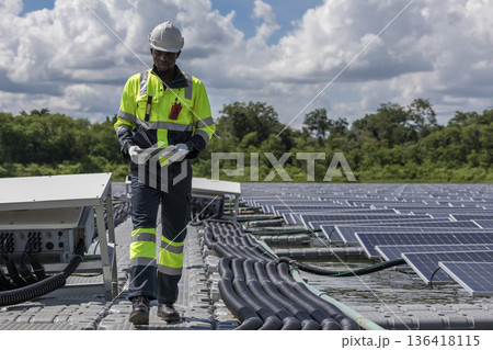 Engineer Checking and working setup Floating solar panels or solar cell Platform system on the lake. Engineer Checking and working setup Floating solar panels or solar cell Platform system on the lake. 136418115