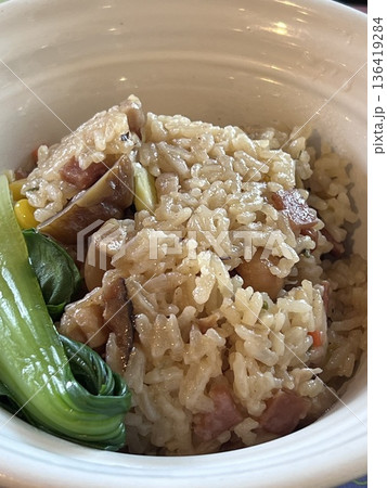 Close up view of delicious asian food, Baked rice and grains with vegetables in a bowl on the table Close up view of delicious asian food, Baked rice and grains with vegetables in a bowl on the table 136419284