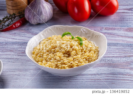 Boiled ptitim pasta served basil 136419852