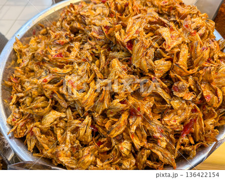Spicy dried fish with chili in metal bowl Spicy dried fish with chili in metal bowl 136422154