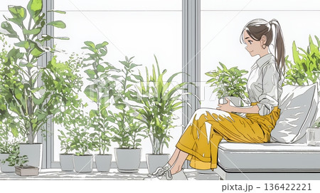 観葉植物の世話をする若い女性