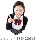 笑顔で上を指差す制服姿の日本人女子学生（俯瞰・切り抜き・コピースペース・白バック）	 136422613