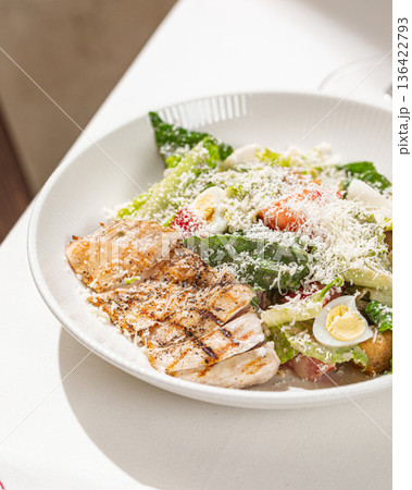Caesar salad with grilled chicken and parmesan Caesar salad with grilled chicken and parmesan 136422793