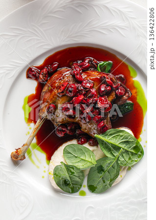 Duck confit leg with berry sauce 136422806