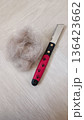 Pet hair brush with a clump of collected cat fur after grooming. Isolated on white background. Concept of pet care, shedding season, cleaning and animal hygiene. Copy space included. 136423662