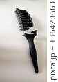 Close-up of a broken and cracked plastic comb on a clean white background. Represents concepts of cheap products, breakage, disappointment, plastic pollution. Has ample copy space for text or design. 136423663