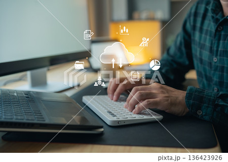 Man typing on keyboard with cloud computing technology, cloud storage, data transfer, and digital business management network concept 136423926