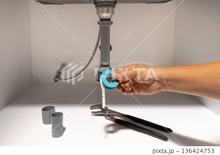 Handyman use thread seal tape for  fix leaking water under sink. 136424753