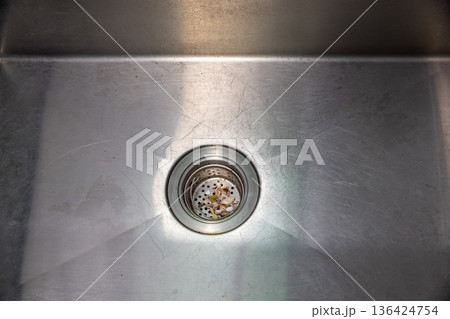 Food scraps in the basket strianer of sink Food scraps in the basket strianer of sink 136424754