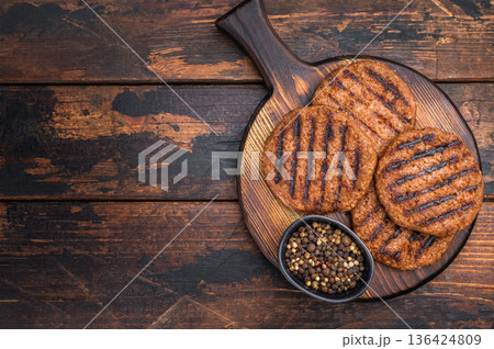 Vegan meatless burger patties grilled and ready to eat plant based protein bbq food isolated background 136424809