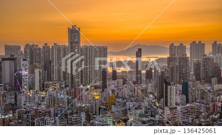 Golden sunset illuminates dense Kowloon West urban skyline Feb 6 2026 136425061