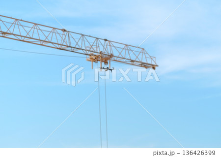Mini quadcopter flying on sky to surveillance working from building construction site on top view 136426399