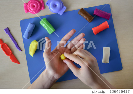 Kids modeling master class flat lay step 3 forming small details for handmade plasticine sweets candy and lollipops creative education fine motor skills development diy craft concept Kids modeling master class flat lay step 3 forming small details for handmade plasticine sweets candy and lollipops creative education fine motor skills development diy craft concept 136426437