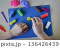 Kids plasticine sweets candy and lollipops modeling flat lay step 5 shaping round elements for handmade candy creative play diy craft fine motor skills development educational concept 136426439