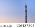 Antenna communication station tower on sunset sky 136427208