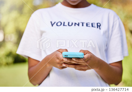 Person hands, phone typing and volunteering in park with social media FAQ, blog or community service chat. Volunteer on search mobile for earth day communication, NGO or nonprofit contact in nature 136427714