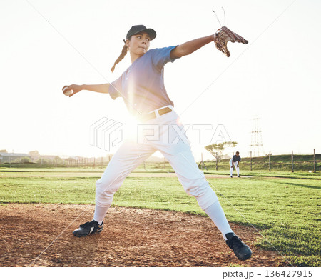Pitching a ball, baseball and person outdoor on a pitch for sports, performance and competition. Professional athlete or softball player for a game, training or exercise challenge at field or stadium Pitching a ball, baseball and person outdoor on a pitch for sports, performance and competition. Professional athlete or softball player for a game, training or exercise challenge at field or stadium 136427915