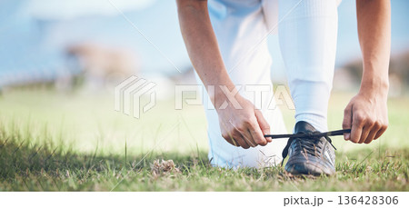Hands, feet and a sports person tying laces on a baseball field outdoor with mockup space for fitness. Exercise, shoes and getting ready with an athlete on a pitch for a match or training closeup 136428306