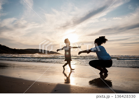 Kid is running to mom, beach and silhouette, family with games and love, travel and freedom together outdoor. People, sunset and adventure, woman and girl bonding on tropical holiday and nature 136428330