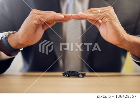Investment, hands and person with car insurance or covering for safety or business. Office, protection and man with shelter or security for transportation, guarantee or premium support for a vehicle Investment, hands and person with car insurance or covering for safety or business. Office, protection and man with shelter or security for transportation, guarantee or premium support for a vehicle 136428557