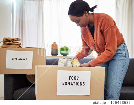 Food, donation and volunteer with black woman and box for charity, helping and support. Grocery, community service and hope with person at home for ngo package, nonprofit and social responsibility 136428685