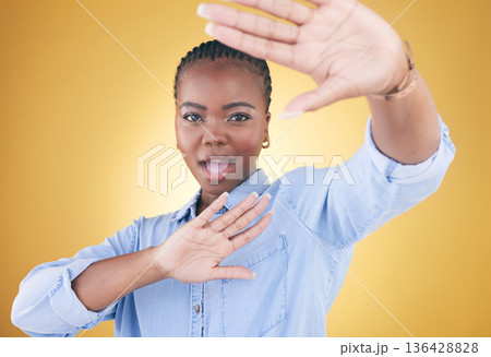 Fashion, hands frame and portrait of black woman in studio for confident, style or beauty. Photography, perspective and face of African person on yellow background in cosmetics, makeup and creativity Fashion, hands frame and portrait of black woman in studio for confident, style or beauty. Photography, perspective and face of African person on yellow background in cosmetics, makeup and creativity 136428828