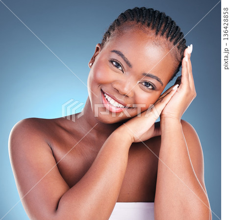 Skincare, portrait and black woman with natural beauty, shine and dermatology on a blue studio background. Person, face or model with makeup, wellness and treatment with health, glow and smooth skin Skincare, portrait and black woman with natural beauty, shine and dermatology on a blue studio background. Person, face or model with makeup, wellness and treatment with health, glow and smooth skin 136428858