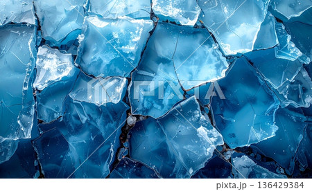 A macro shot of blue ice texture reveals transparent frozen crystals and a clear abstract pattern of frost inside a cold glass cube of water A macro shot of blue ice texture reveals transparent frozen crystals and a clear abstract pattern of frost inside a cold glass cube of water 136429384