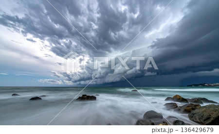 Dramatic storm clouds loom over a dark horizon...のイラスト素材 [136429679 ...