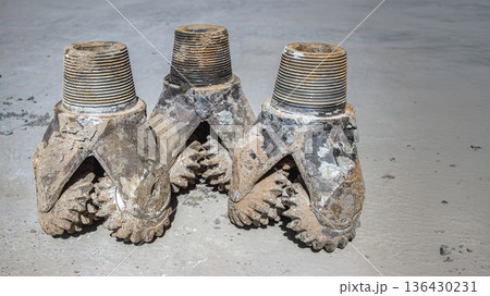 Circular drilling rig tools are shown on the ground. These tools are part of the equipment used in oil and gas extraction activities Circular drilling rig tools are shown on the ground. These tools are part of the equipment used in oil and gas extraction activities 136430231
