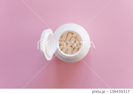 Much medical pills and drugs in white package on the pink background. Healthcare concept. Space for text. 136430317