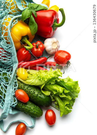 Fresh organic vegetables in a reusable mesh bag 136430679