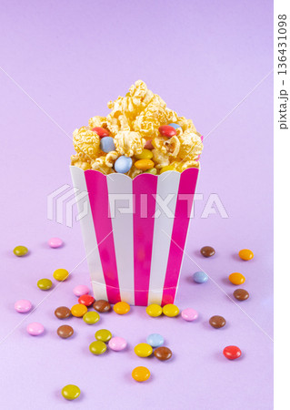 sweet popcorn with dragee on purple background sweet popcorn with dragee on purple background 136431098