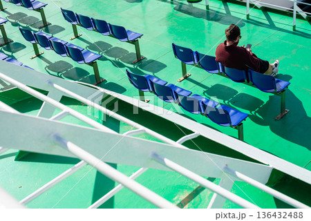 Empty green and blue stadium seating on ferry deck Empty green and blue stadium seating on ferry deck 136432488