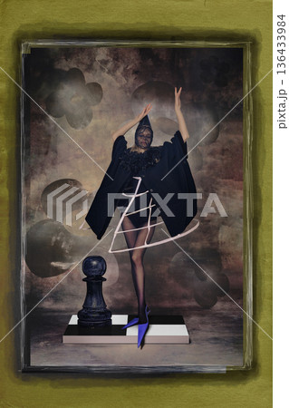 Woman in avantgarde costume standing on chessboard with oversized pawn. Woman in avantgarde costume standing on chessboard with oversized pawn. 136433984