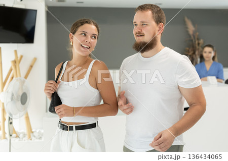 couple stands in front of the reception in the dentistry 136434065