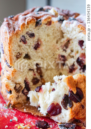 Easter cake with raisins close up. Orthodox Easter celebration. Easter panettone cake with raisins closeup. Spring religious holiday. Christian tradition. Consecrated homemade Easter kulich. Easter cake with raisins close up. Orthodox Easter celebration. Easter panettone cake with raisins closeup. Spring religious holiday. Christian tradition. Consecrated homemade Easter kulich. 136434139