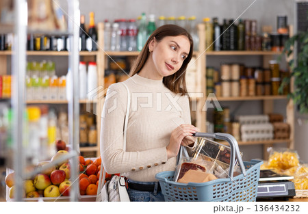 Young woman choosing food in grocery store 136434232
