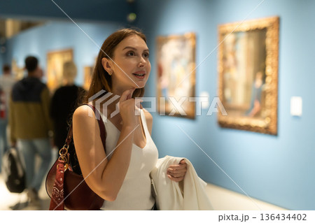 Girl view pictures and icons in museum hall Girl view pictures and icons in museum hall 136434402